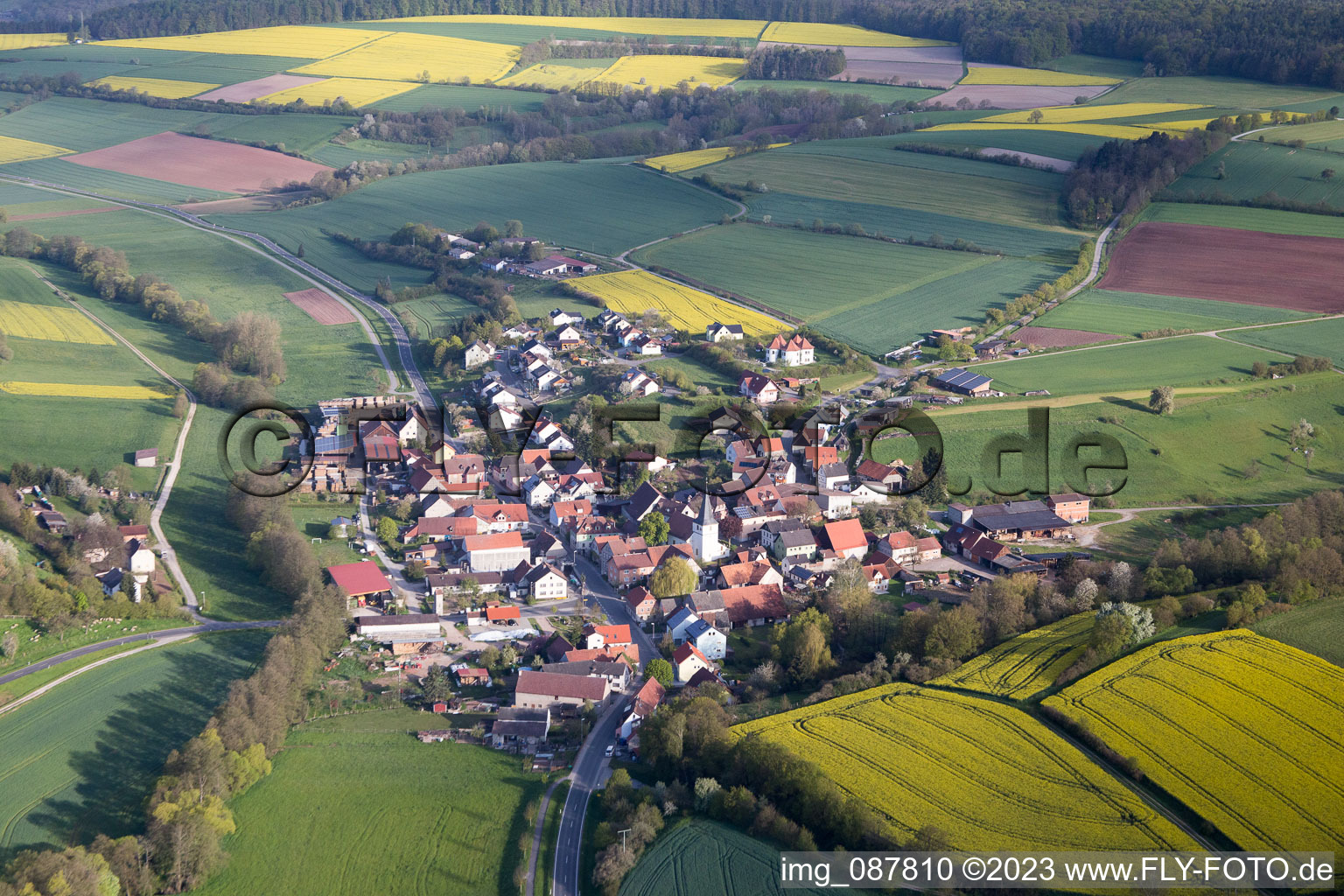 Dorf - Ansicht am Rande von landwirtschaftlichen Feldern und Nutzflächen im Ortsteil Falsbrunn in Rauhenebrach im Bundesland Bayern, Deutschland