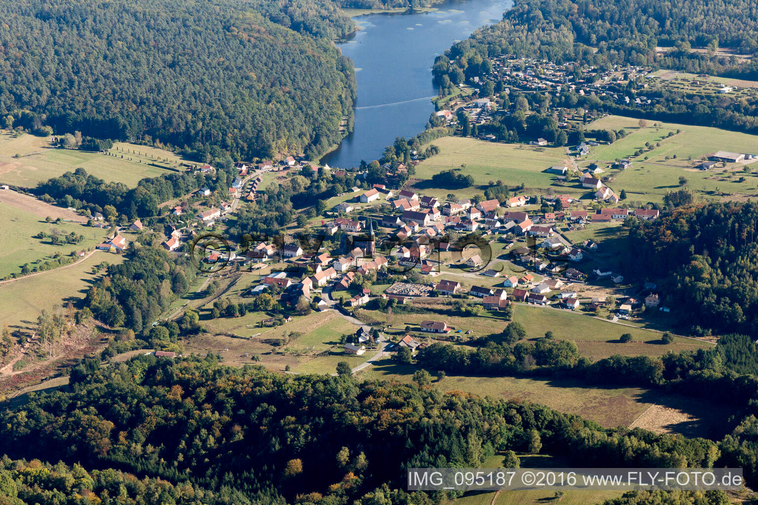 Dorfkern an den See- Uferbereichen des Etang de Haspelschiedt in Haspelschiedt in Grand Est im Bundesland Moselle, Frankreich von oben