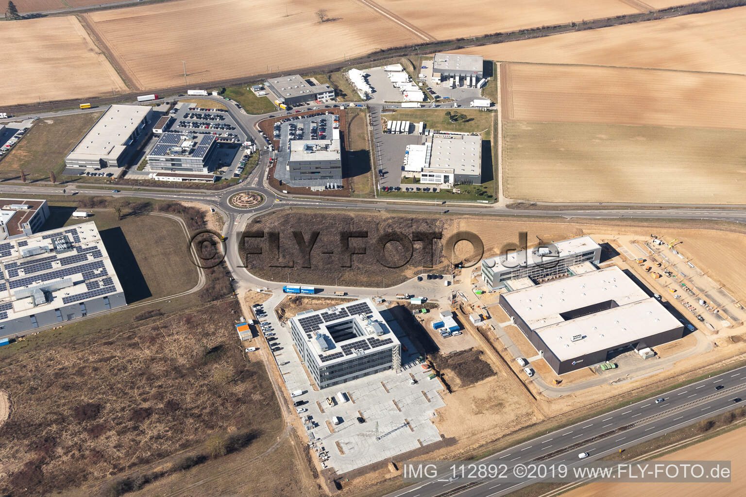 Luftbild von Neubau - Baustelle an den Gebäuden und Produktionshallen des Werksgelände der Eizo GmbH auf dem Gewerbegebiet Nord in Rülzheim im Bundesland Rheinland-Pfalz, Deutschland