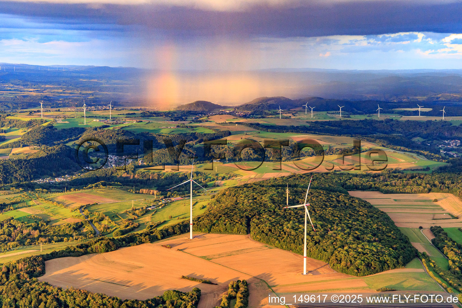 Luftbild von Windpark Merchingen vor einer Regenwand mit Regenbogen in Merzig im Bundesland Saarland, Deutschland