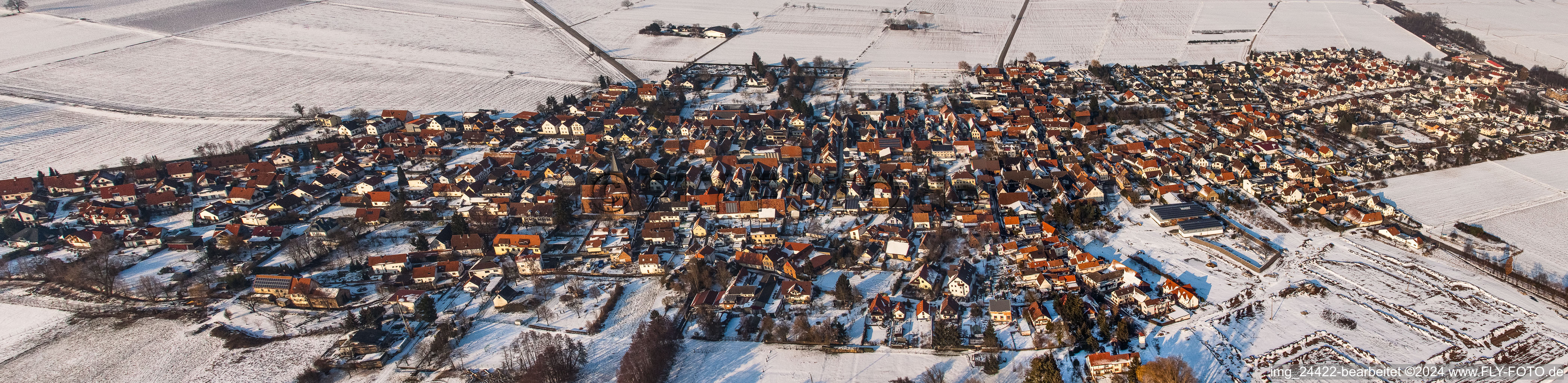 Panorama der Winterlich schneebedeckte Dorf - Ansicht am Rande von landwirtschaftlichen Feldern und Nutzflächen in Rohrbach im Bundesland Rheinland-Pfalz, Deutschland