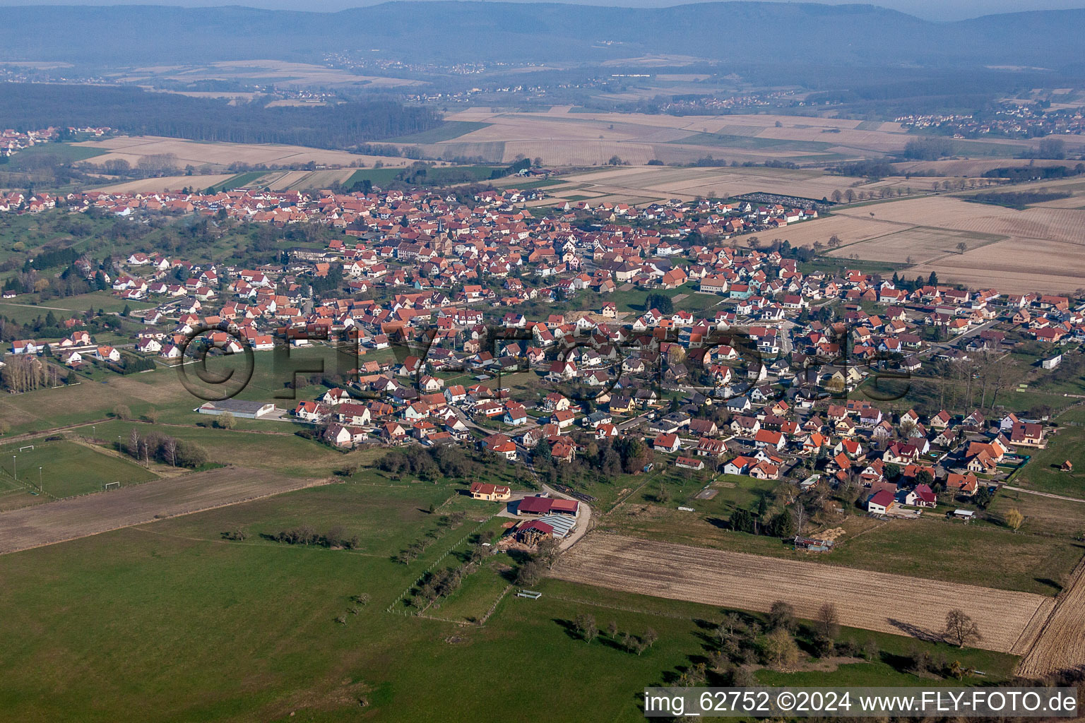 Luftaufnahme von Dorf - Ansicht am Rande von landwirtschaftlichen Feldern und Nutzflächen in Surbourg in Grand Est im Bundesland Bas-Rhin, Frankreich