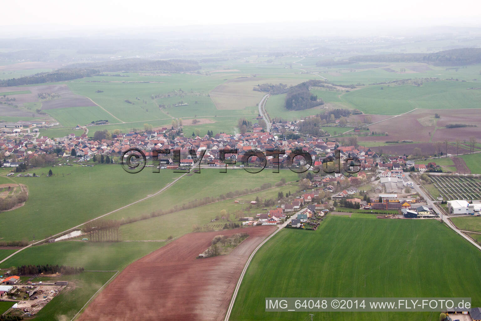 Dorf - Ansicht am Rande von landwirtschaftlichen Feldern und Nutzflächen in Straufhain im Bundesland Thüringen, Deutschland