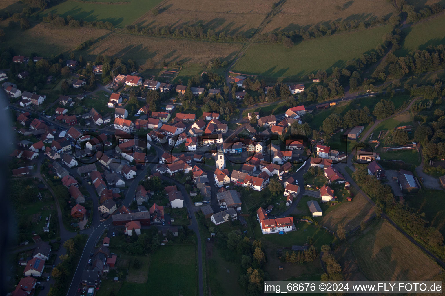 Schrägluftbild von Dorf - Ansicht am Rande von landwirtschaftlichen Feldern und Nutzflächen in Breungeshain in Schotten im Bundesland Hessen, Deutschland