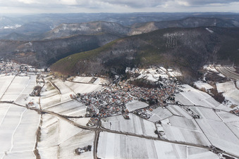 Winterlich schneebedeckte Dorf - Ansicht am Rande von landwirtschaftlichen Feldern und Nutzflächen in Gleisweiler im Bundesland Rheinland-Pfalz, Deutschland