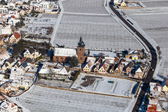 Winterlich schneebedeckte Kirchengebäude der Katholischen Pfarrkirche Maria Heimsuchung, Das Weinhaus Vinothek Meßmer, Ritterhof zur Rose in Burrweiler im Bundesland Rheinland-Pfalz, Deutschland