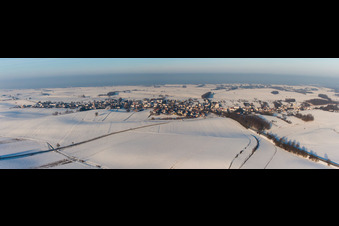Panorama der winterlich schneebedeckten Dorf - Ansicht am Rande von landwirtschaftlichen Feldern und Nutzflächen in Wintzenbach in Grand Est im Bundesland Bas-Rhin, Frankreich