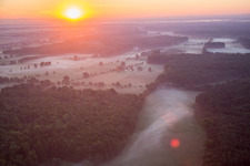 Sonnenaufgang im Morgennebel über der Landschaft Bruchbach-Otterbachniederung in Kandel im Bundesland Rheinland-Pfalz, Deutschland